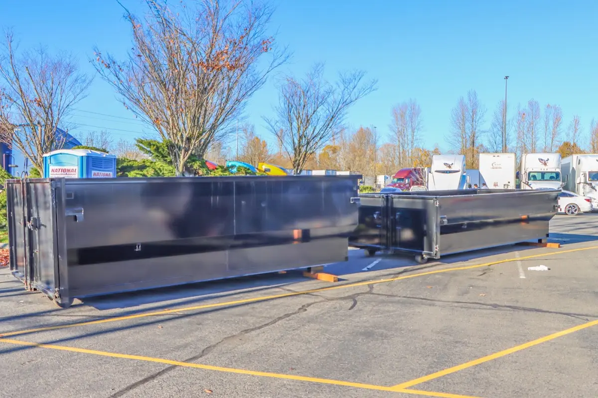 Professional dumpster rental service with roll-off container on residential driveway in Allentown